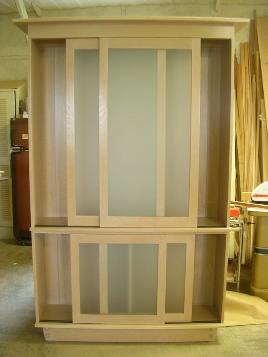 White Oak linen cabinet with sliding doors by Nolan Wallenfang Custom Woodwork, Green Lake Wisconsin WI